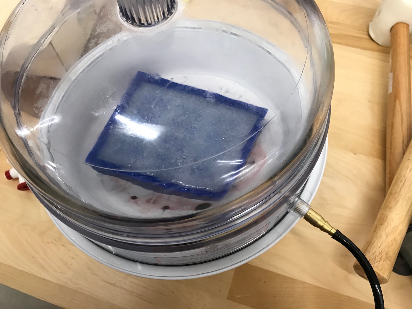 Silicone poured into countermold placed in vacuum chamber